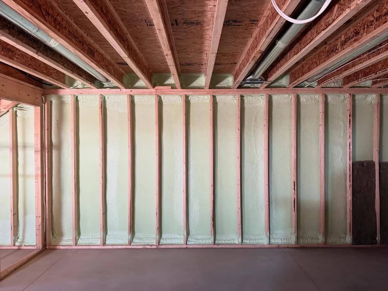 Basement foundation wall insulated with closed-cell spray foam