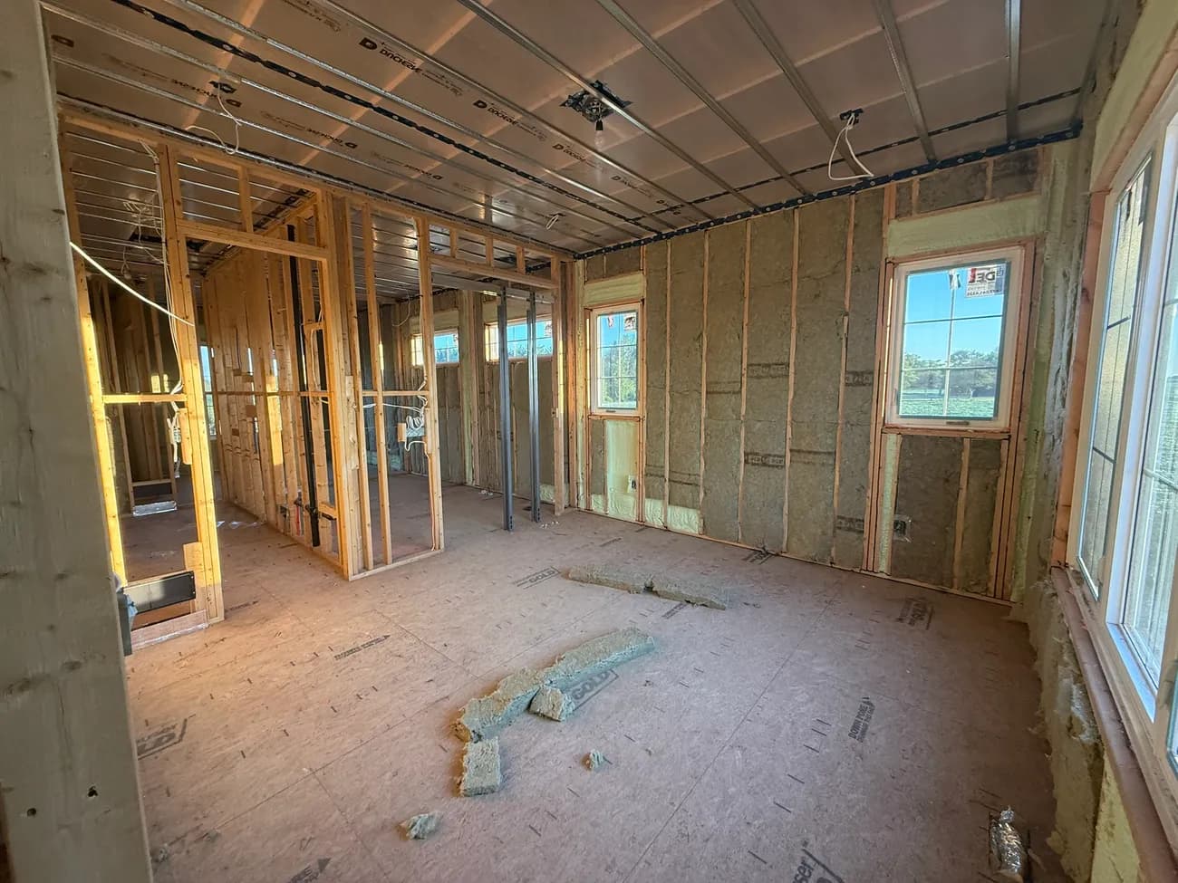 New home under construction with closed-cell spray foam in the wall cavities