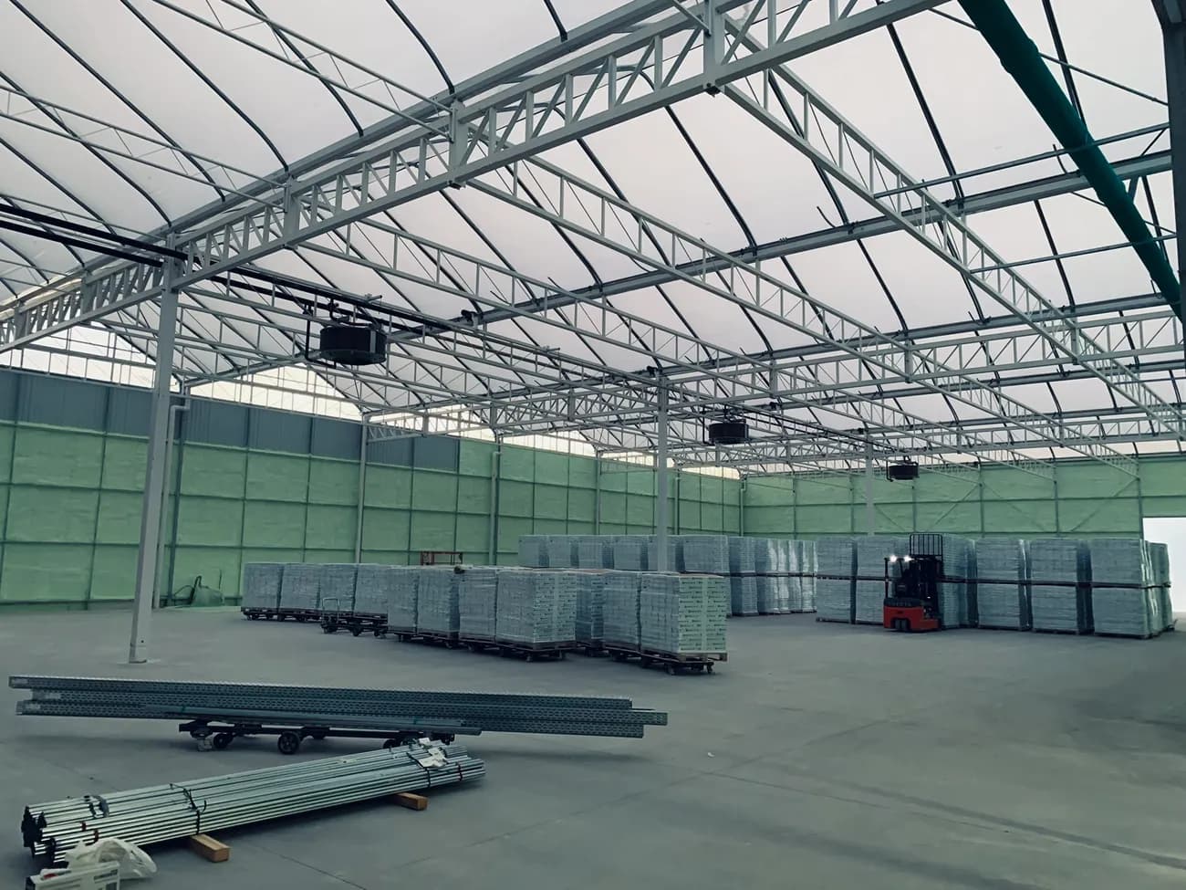 Warehouse interior with closed-cell spray foam on steel walls and deck